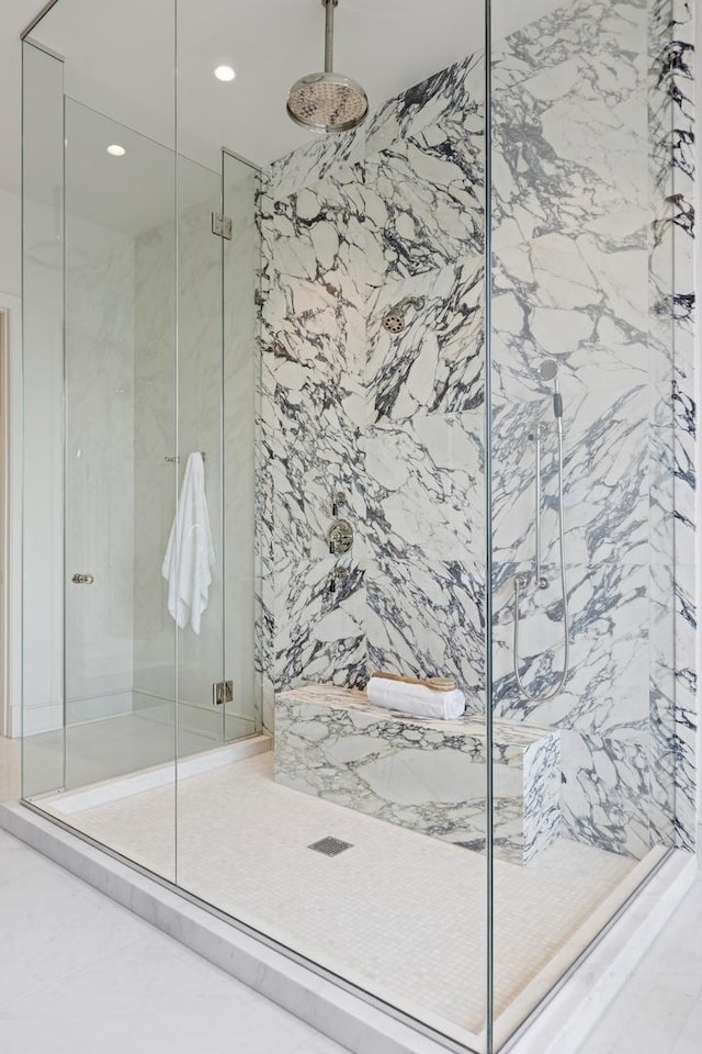 bathroom featuring a marble finish shower