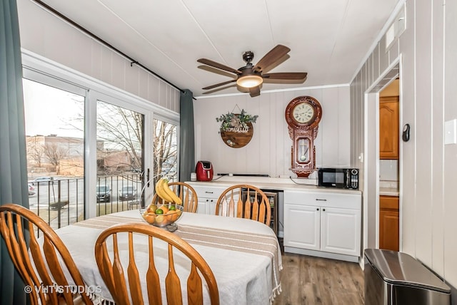 dining area featuring light wood finished floors and a ceiling fan