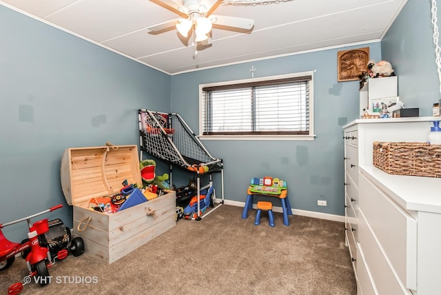 recreation room featuring carpet, baseboards, and a ceiling fan