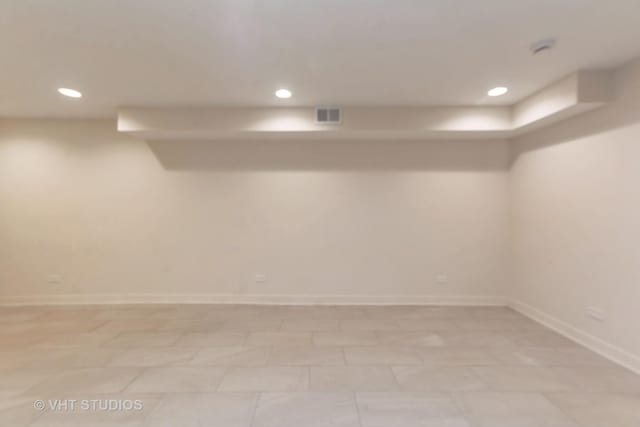 finished below grade area with baseboards, visible vents, and recessed lighting