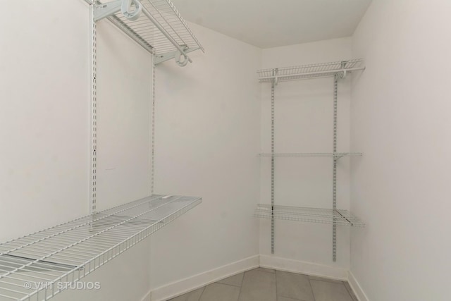 walk in closet with tile patterned floors