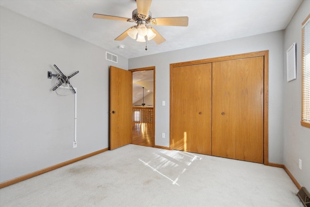 unfurnished bedroom featuring a closet, carpet flooring, visible vents, and baseboards