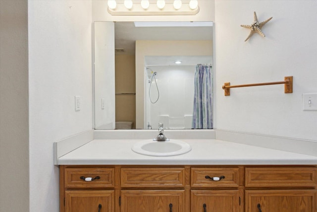 bathroom with vanity, toilet, and a shower with curtain