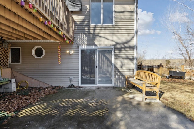 back of property with fence and a patio