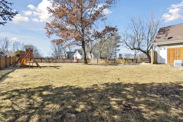 view of yard featuring a playground and a fenced backyard