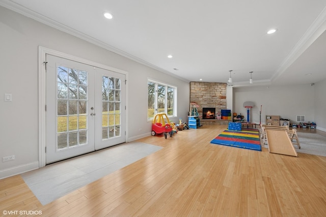 exercise area with ornamental molding, french doors, wood finished floors, and recessed lighting