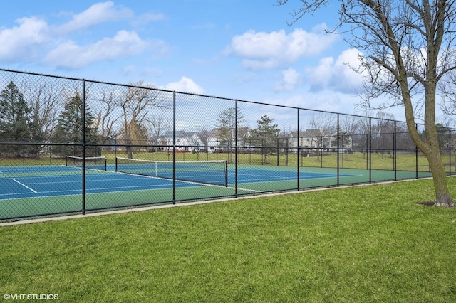 view of sport court featuring a yard and fence