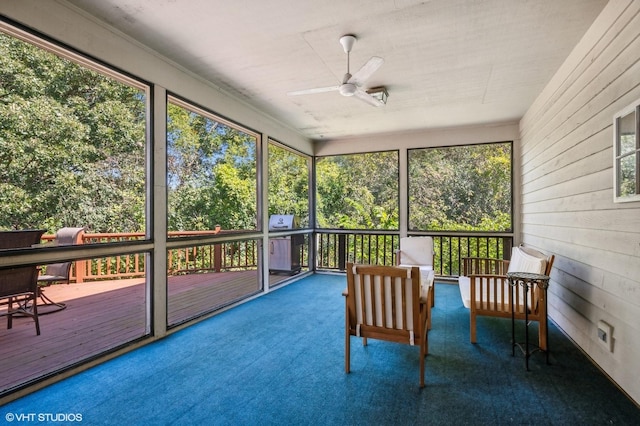 unfurnished sunroom featuring ceiling fan