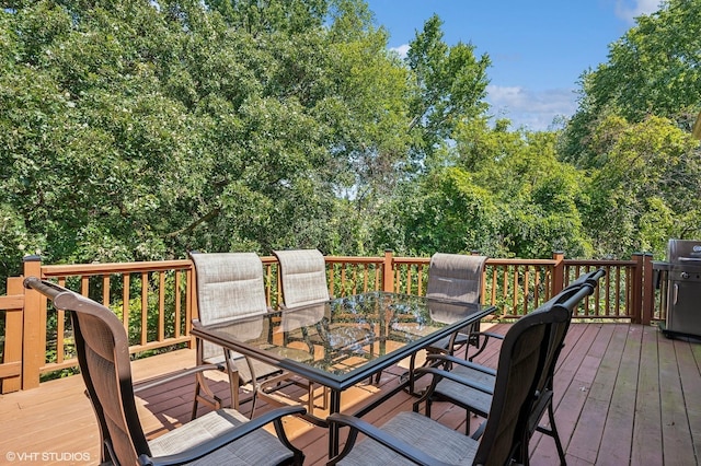 deck featuring grilling area and outdoor dining space