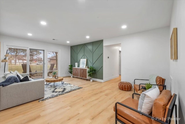 living room with baseboards, wood finished floors, and recessed lighting