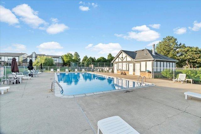 pool featuring a patio area and fence