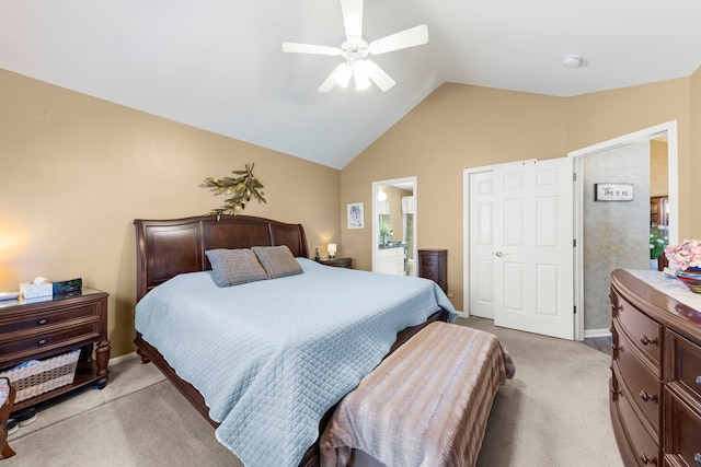 bedroom with light carpet, baseboards, a ceiling fan, lofted ceiling, and ensuite bath