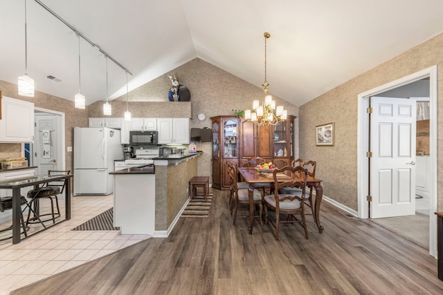 kitchen featuring dark countertops, light wood-style flooring, white cabinetry, a chandelier, and white appliances