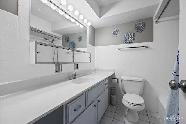 bathroom with toilet, tile walls, tile patterned flooring, a shower, and vanity