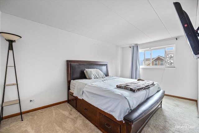 bedroom featuring baseboards and light carpet