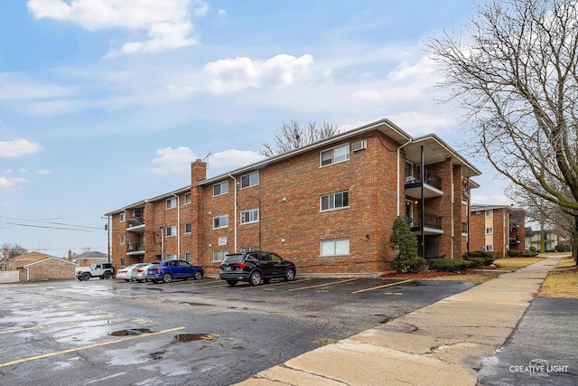 view of property featuring uncovered parking