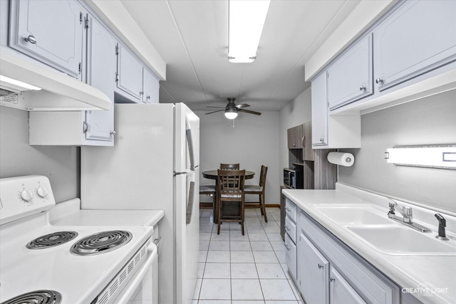 kitchen with under cabinet range hood, light countertops, white electric range oven, a ceiling fan, and a sink