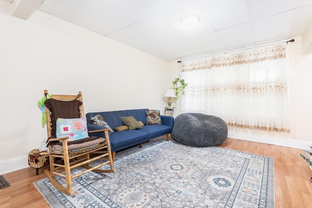 living area featuring baseboards and wood finished floors