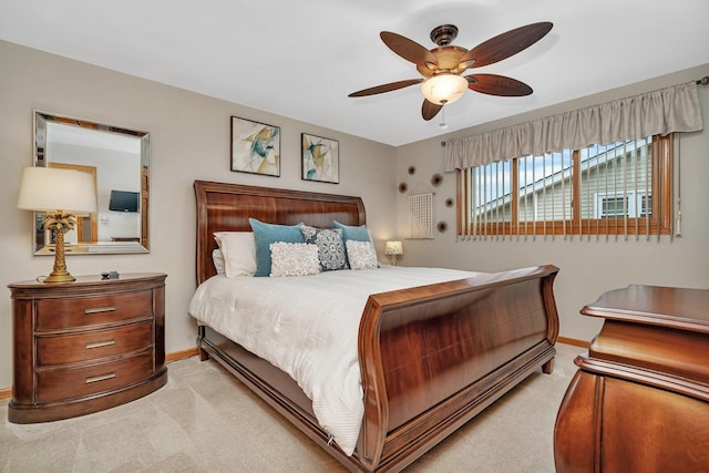 bedroom with baseboards, ceiling fan, and light colored carpet