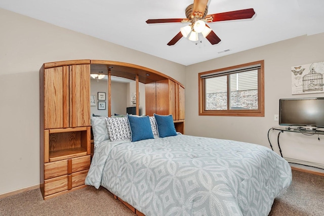 carpeted bedroom with ceiling fan, visible vents, and baseboards