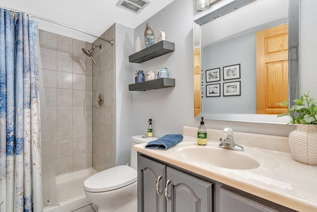 full bath with visible vents, a shower stall, toilet, and vanity