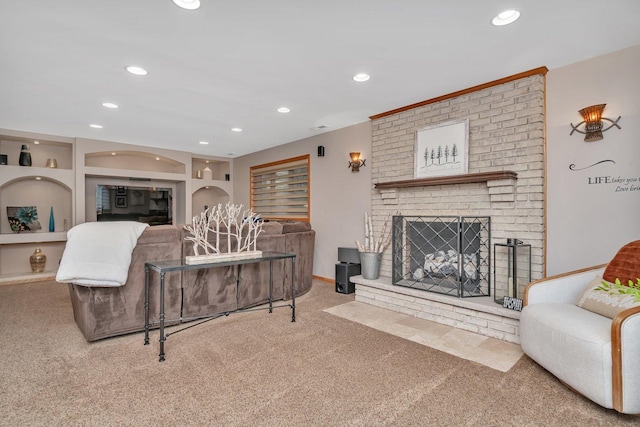 carpeted living area featuring built in features, recessed lighting, and a brick fireplace