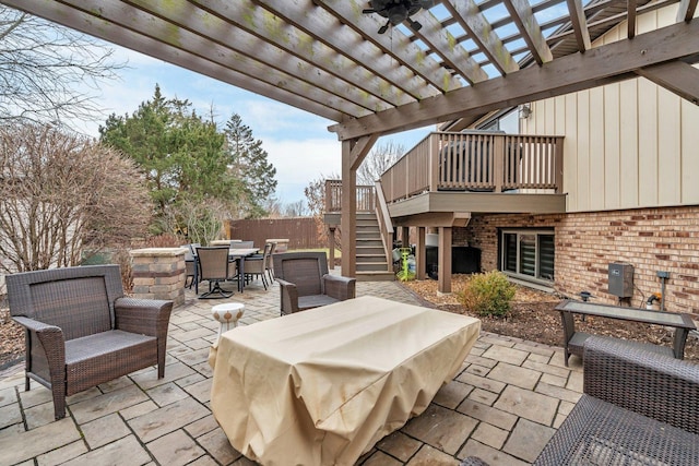 view of patio featuring stairway, outdoor dining area, and a pergola