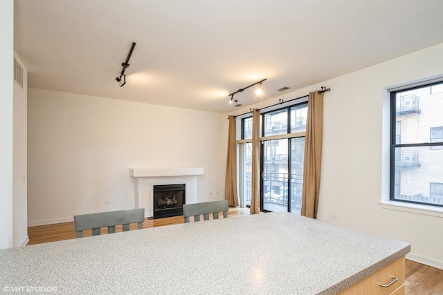 living room with visible vents, a fireplace, and light wood finished floors