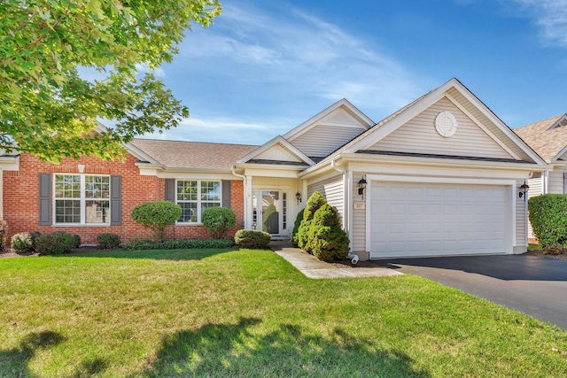 view of front of property featuring aphalt driveway, a front yard, brick siding, and a garage