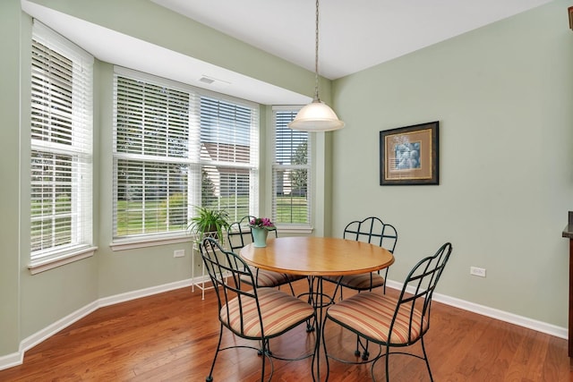 dining area featuring wood finished floors and baseboards