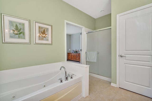 full bath with a jetted tub, tile patterned flooring, a shower stall, and baseboards