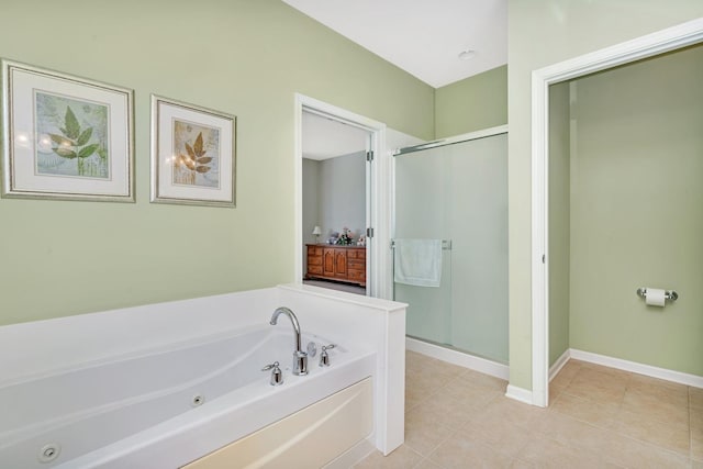 full bathroom featuring baseboards, a jetted tub, a shower stall, and tile patterned floors