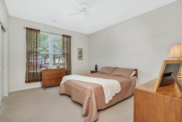 bedroom featuring visible vents, ceiling fan, light carpet, and baseboards