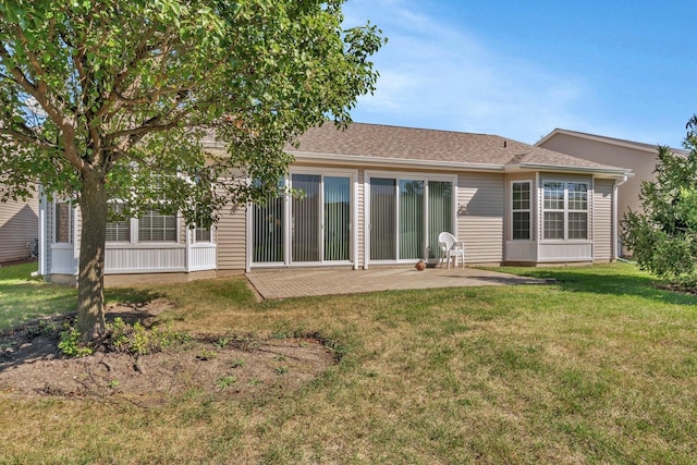 back of property featuring a lawn and a patio