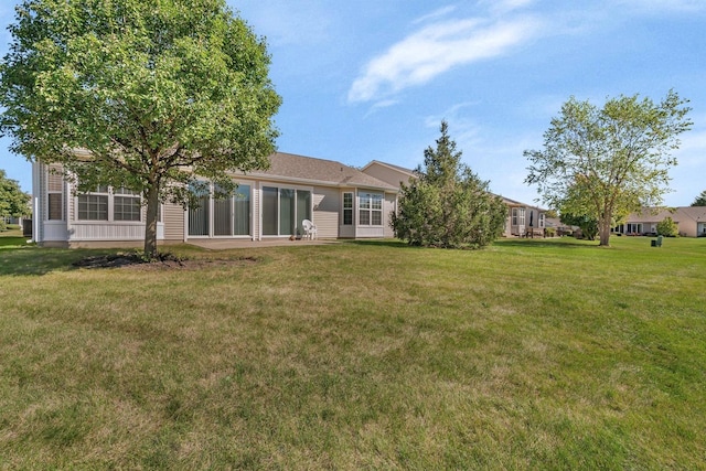 rear view of property featuring a yard