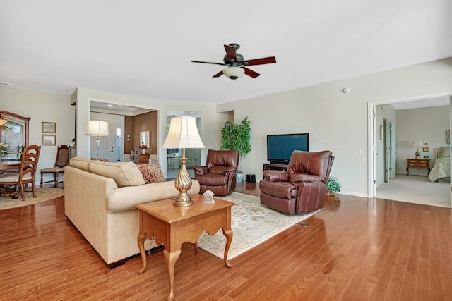 living room featuring wood finished floors and a ceiling fan