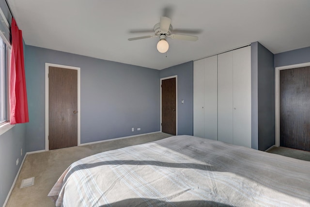 bedroom with carpet floors, visible vents, baseboards, and a ceiling fan