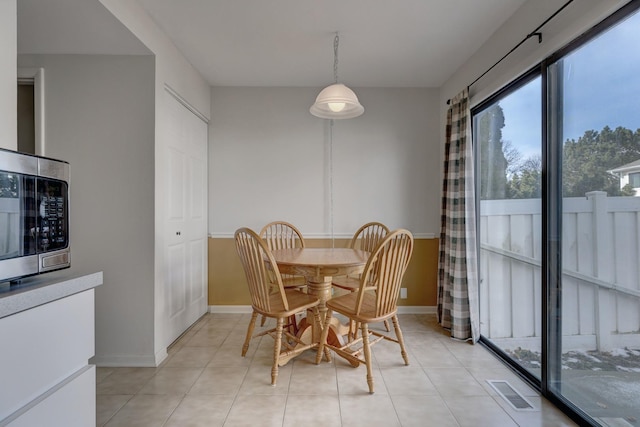 dining area with visible vents, baseboards, and light tile patterned floors