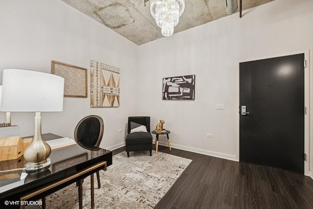 home office featuring baseboards, wood finished floors, and a notable chandelier