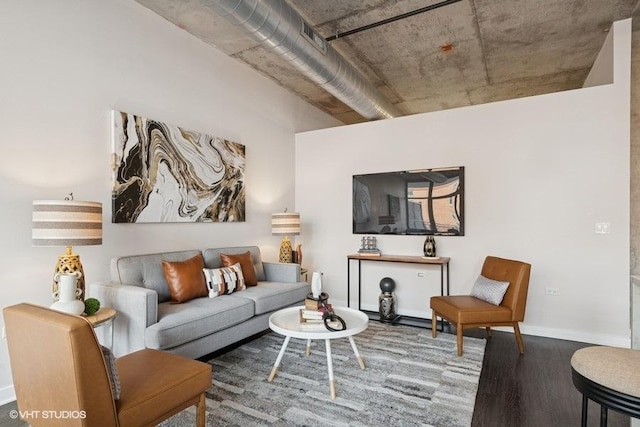 living area featuring baseboards and wood finished floors