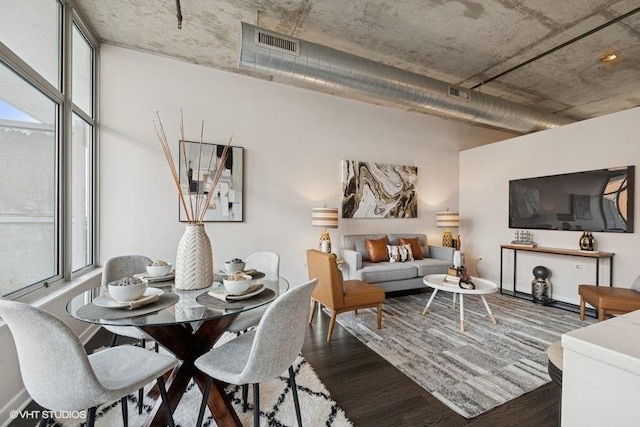 dining space featuring visible vents and wood finished floors