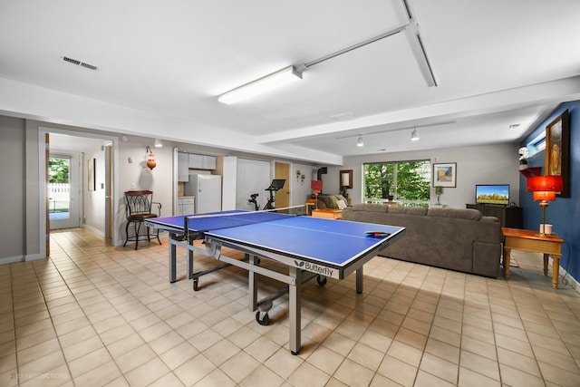 playroom featuring light tile patterned floors, baseboards, visible vents, and a healthy amount of sunlight