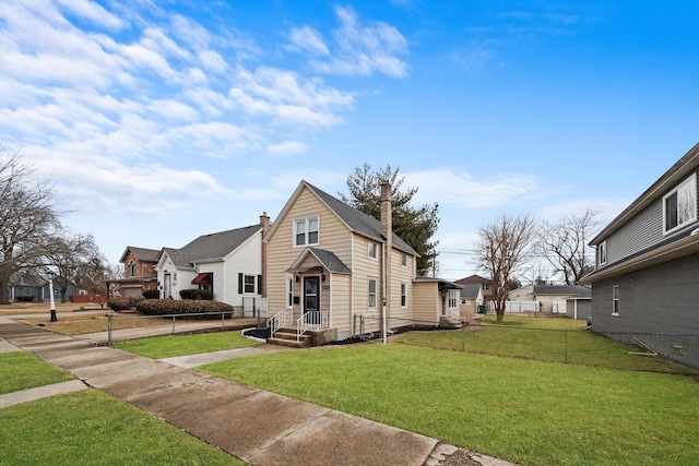 view of front of property with a chimney, entry steps, fence, a residential view, and a front lawn