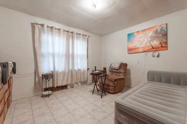 sitting room featuring baseboards and light tile patterned floors