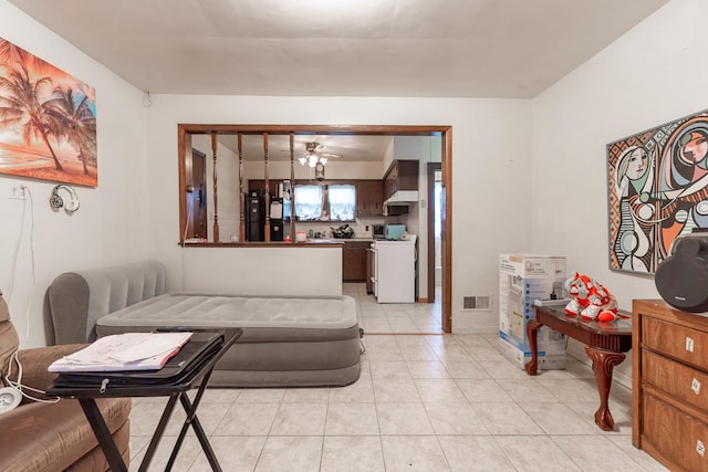 living area with visible vents and light tile patterned flooring