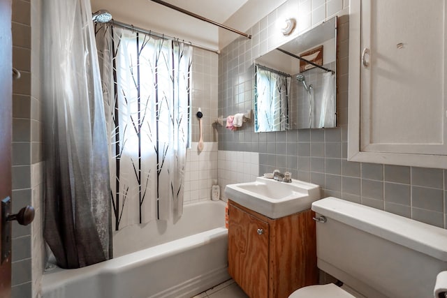 bathroom with decorative backsplash, toilet, shower / bath combo with shower curtain, vanity, and tile walls