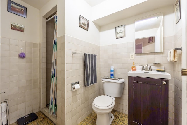 bathroom featuring a tile shower, tile walls, toilet, and vanity