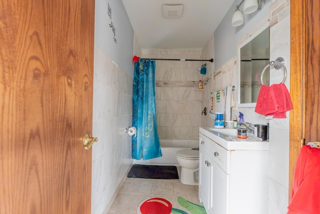 full bath with tile patterned flooring, toilet, vanity, tile walls, and shower / tub combo with curtain