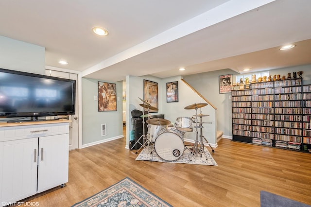 interior space featuring light wood-style floors, baseboards, and recessed lighting