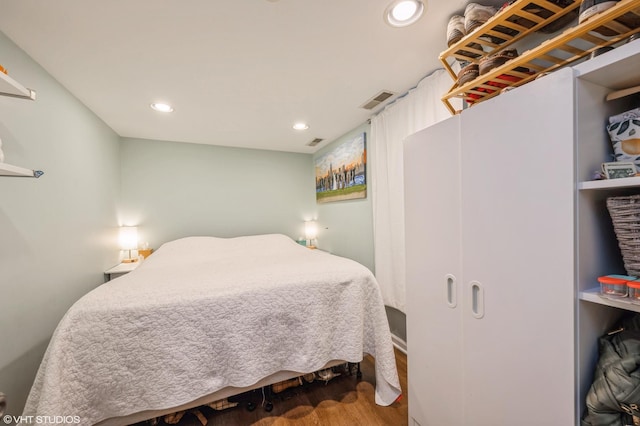 bedroom featuring recessed lighting, visible vents, and wood finished floors